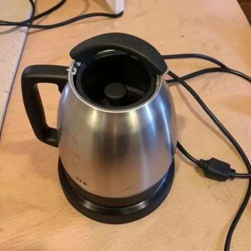 Hervidor de agua con tapa abierta, base separada y detalle del cable para evaluar seguridad y desgaste real